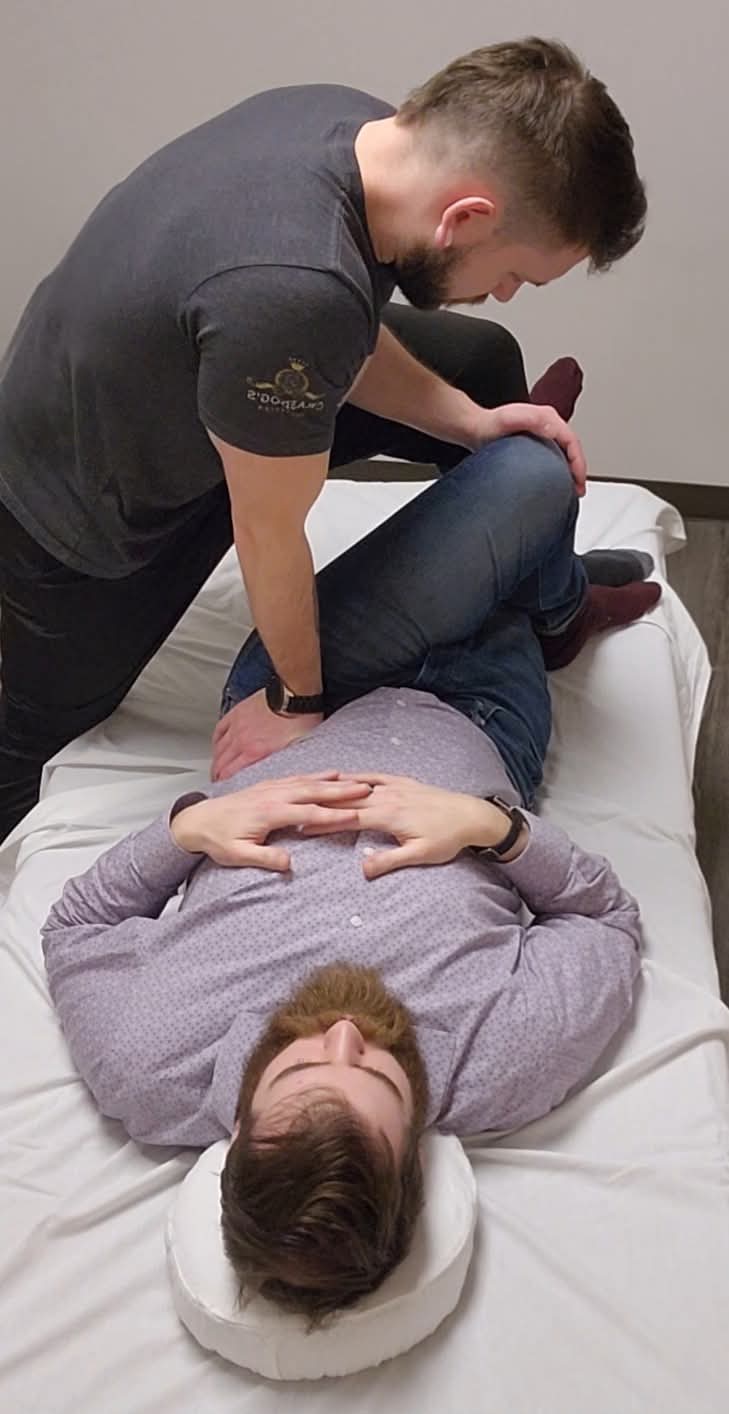Tyler providing hands-on movement support during a guided session